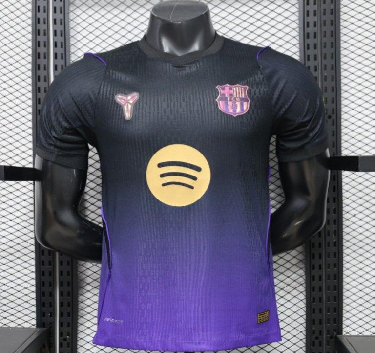 A dark purple and black gradient FC Barcelona soccer jersey with a gold Spotify sponsor logo on the chest, displayed on a black mannequin torso against a gray mesh background.